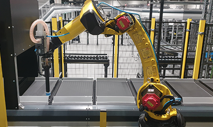 Robot arm inducting directly onto the Cross Tray Sorter